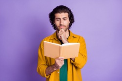 Photo of young brown hair man red book serious focused hand touch chin isolated over purple color background
