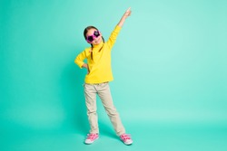 Full length photo of happy brown haired cheerful little girl wear star glasses make pose isolated on teal color background