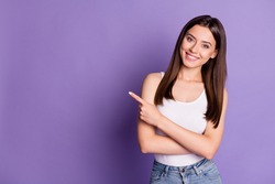 Photo of cute adorable young woman wear casual white outfit pointing empty space isolated violet color background