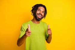 Photo of positive cheerful dark skin guy point index finger in camera isolated over bright yellow color background