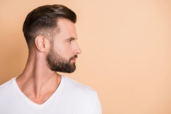 Profile side photo of young handsome bristle man confident look empty space isolated over beige color background