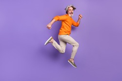 Full size profile side photo of mature man happy positive smile go walk run jump hurry sale isolated over purple color background