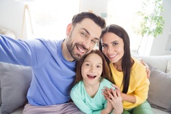 Photo of cheerful family happy positive smile make selfie record video enjoy time together sit couch indoors
