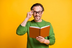 Photo of man hold diary read adjust specs curious wear green sweater isolated yellow color background