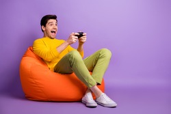 Full body profile portrait of crazy guy playing game open mouth look empty space isolated on purple color background