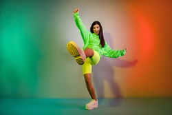 Full length body size view of pretty funky cheerful girl dancing good mood isolated over multicolor vivid neon light background
