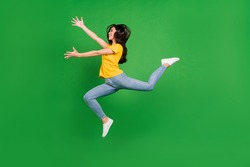 Full length body size side profile photo dreamy girl brunette jumping running catching isolated vibrant green color background