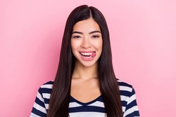 Photo of funky funny young lady dressed striped clothes smiling licking lips isolated pink color background