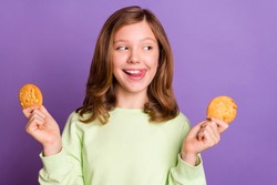 Photo of young cheerful girl happy positive smile lick tongue lips hungry delicious cookies isolated over violet color background