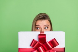 Photo portrait girl hiding face behind big present box isolated pastel green color background