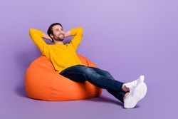 Full length body size photo man laying in beanbag chilling dreamy looking copyspace isolated pastel purple color background