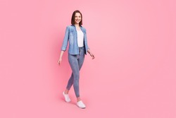 Full length body size photo girl smiling confident wearing stylish outfit walking forward isolated pastel pink color background