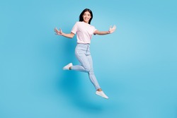 Full body profile side photo of young asian girl happy positive smile have fun jump isolated over blue color background