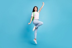 Full length body size view of attractive cheerful teen girl jumping going to high school isolated over bright blue color background
