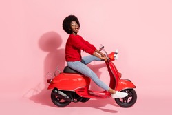 Profile side view portrait of nice funny cheerful girl riding moped without legs having fun isolated over pink pastel color background