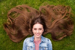 Top above high angle view photo of young cheerful girl happy positive smile lying grass haircare enjoy rest relax outdoors