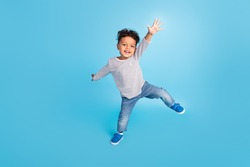 Full length body size view of attractive cheerful carefree boy dancing good mood isolated over bright blue color background