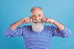 Portrait of attractive cheerful content grey-haired man touching mustache fixing isolated over bright blue color background