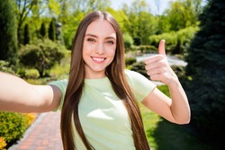 Photo of young girl happy positive smile make selfie show thumb-up perfect great feedback advice park summer nature