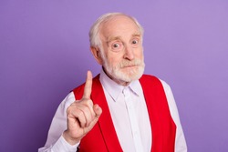 Photo of happy old man hold finger attention caution warning wear red vest isolated on purple color background