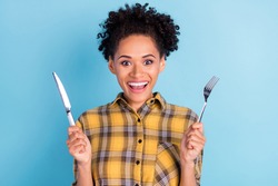 Photo portrait curly woman keeping fork knife smiling hungry isolated pastel blue color background