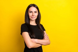 Profile portrait of half turned charming girl folded arms look camera isolated on yellow color background