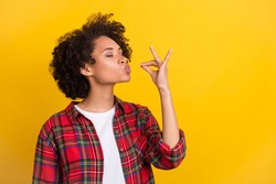 Portrait of attractive dreamy cheerful girl tasting invisible meal dish isolated over bright yellow color background