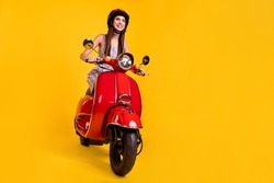 Full length body size photo smiling girl riding motorbike looking blank space isolated vivid yellow color background