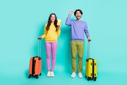 Full size photo of young couple happy positive smile vacation baggage tickets abroad fly isolated over teal color background
