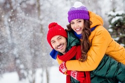 Photo of charming pretty marriage couple wear windbreakers embracing smiling having fun walking snowy weather outside park
