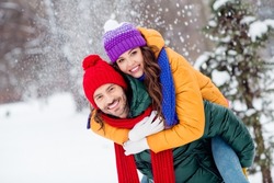 Photo of sweet cute marriage couple wear windbreakers hugging smiling having fun walking snowy weather outside park