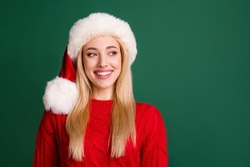 Photo of pretty nice positive woman look empty space wear santa claus hat smile isolated on green color background
