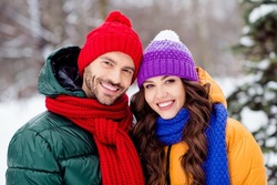 Photo of charming pretty marriage couple wear windbreakers enjoying snowy weather embracing smiling outside park
