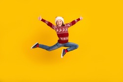 Full body photo of positive cheerful small girl jump up make thumbs up promoter isolated on yellow color background
