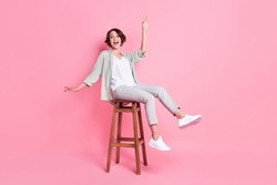 Full length photo of funny bob hairdo millennial lady sit dance wear grey green look isolated on pink background