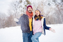 Portrait of carefree satisfied persons have fun hand palm catch throw snow beaming smile enjoy date in forest outdoors