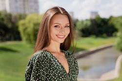 Photo of attractive young charming happy woman smile good mood enjoy weekend outdoors outside park street