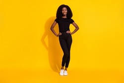 Full body photo of millennial young lady stand wear black cloth isolated on yellow color background