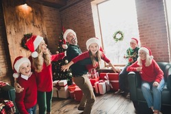 Photo of family friends small little childhood children wear santa claus hat people parents grandfather grandmother noel xmas indoors house