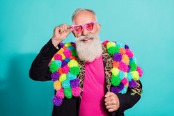 Photo of funky cool senior hipster wear handmade pop-pom blazer arm eyeglasses smiling isolated teal color background