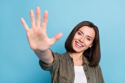 Photo of positive cheerful lady show fifth arms fingers math concept wear khaki clothes isolated over blue color background