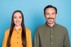 Portrait of two cheerful positive persons toothy smile look camera have good mood isolated on blue color background