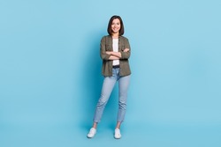 Full body photo of cool satisfied glad lady stand with folded arms wear khaki clothes isolated over sky light color background