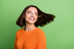 Portrait of attractive cheerful dreamy girl throwing hair enjoying dream isolated over bright green color background