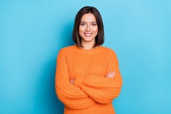 Portrait of attractive cheerful content girl folded arms wearing warm wool jumper isolated over bright blue color background
