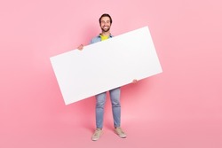 Full size photo of young cheerful man hold empty paper card advertise isolated over pink color background