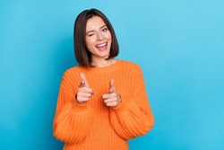 Portrait of attractive flirty funny cheerful girl winking pointing forefingers at you isolated over vibrant blue color background