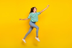 Full size profile side photo of youth lady run walk try to catch look empty space isolated over yellow color background
