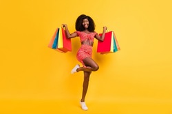 Full size image feminine woman enjoy black friday go shopping big sale discount isolated on yellow color background