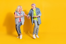 Photo of sweet adorable husband wife wear jeans shirts dancing empty space isolated yellow color background
